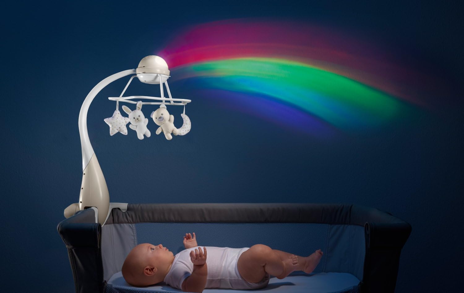 Baby in Next2Me cot with Chicco mobile projecting rainbow