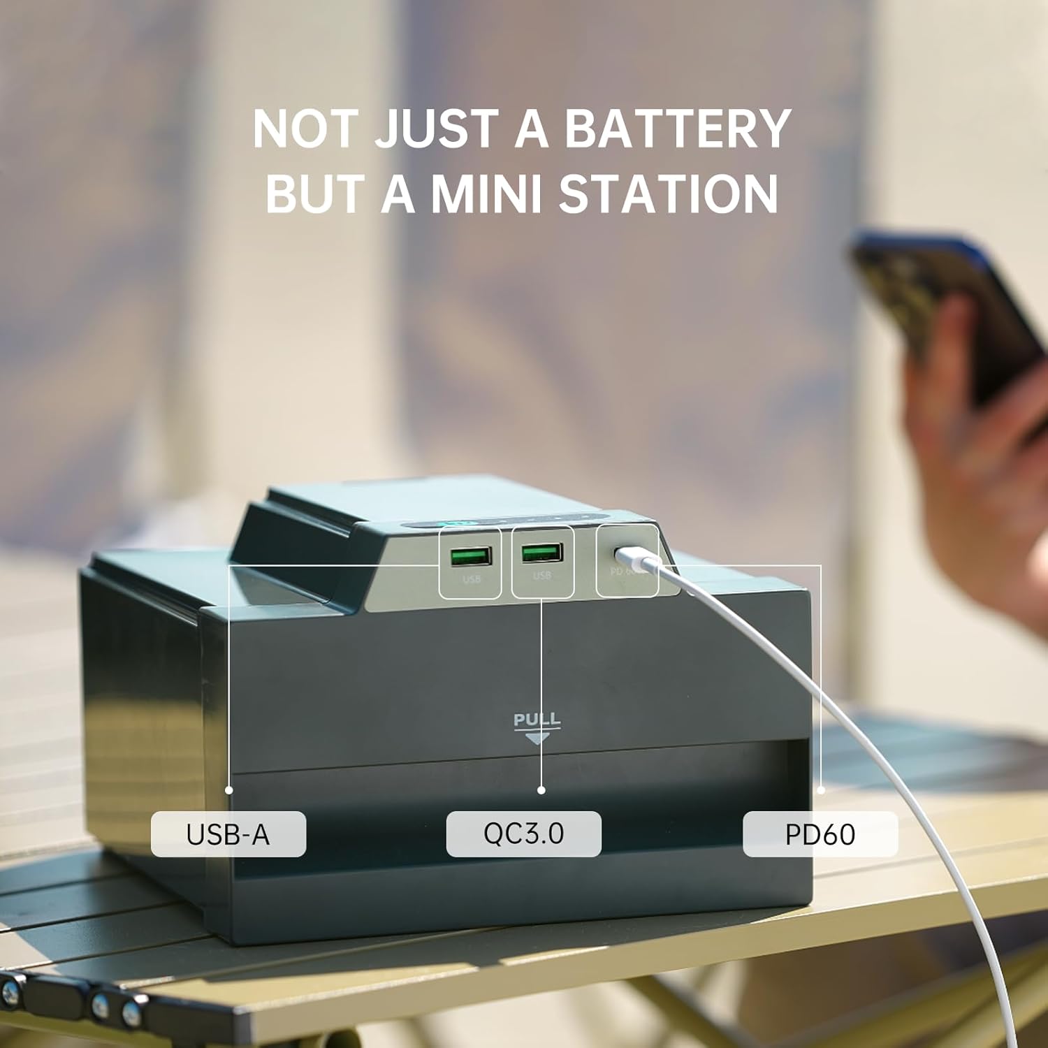 Child inserting a removable battery into the iGo3600 Power Station on a beach table.