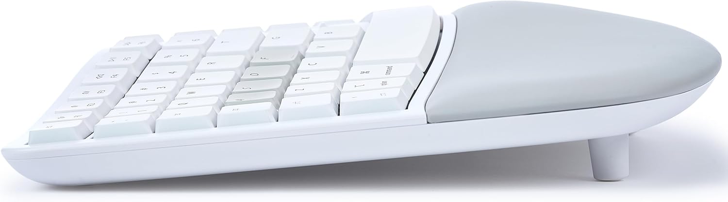 Strona view of the KINESIS mWave keyboard with magnetic feet attached, demonstrating the negative tilt for ergonomic typing.