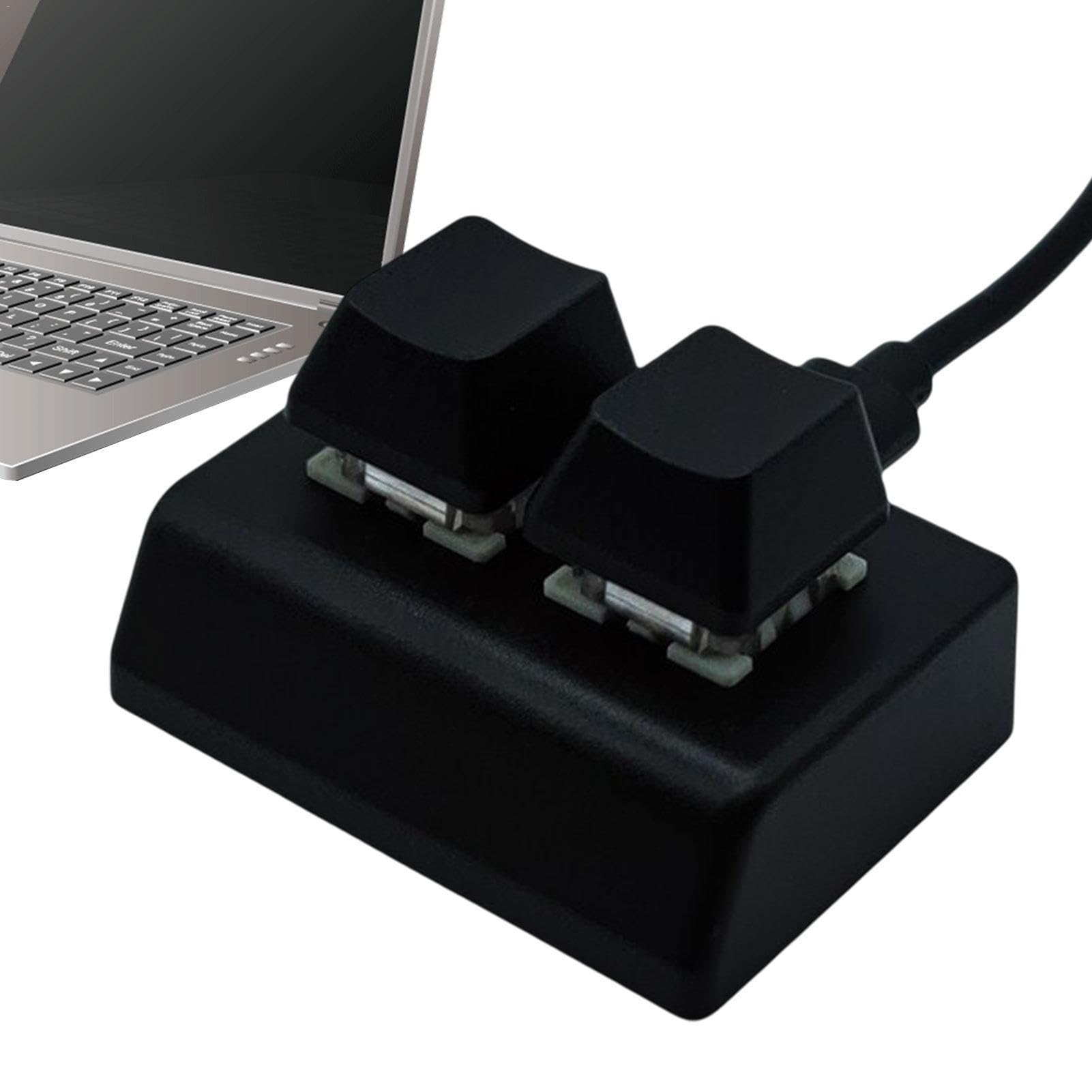 Person using the 2-key mechanical keyboard alongside a laptop