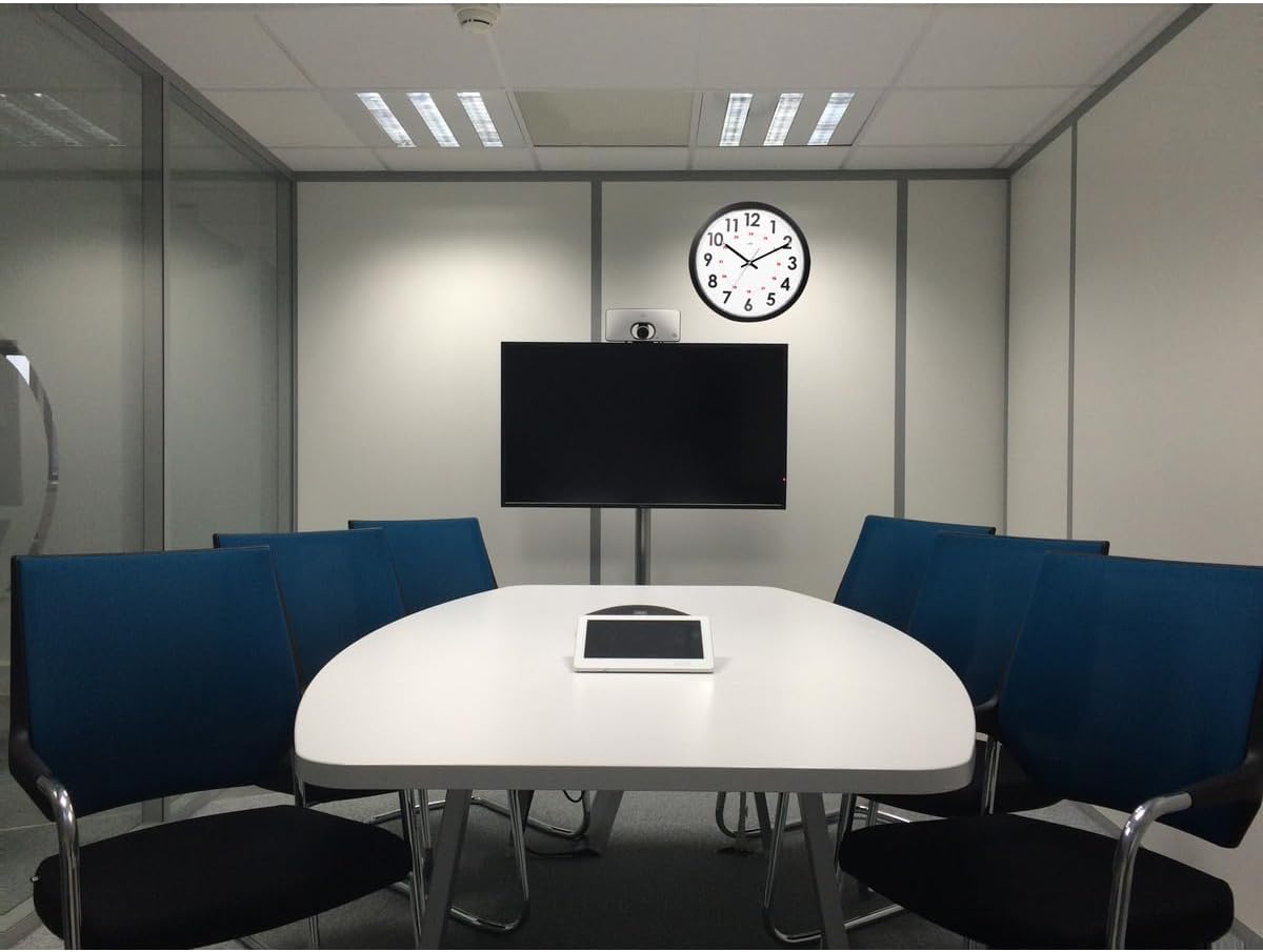 Orium Display Clock mounted on a wall in a modern office meeting room