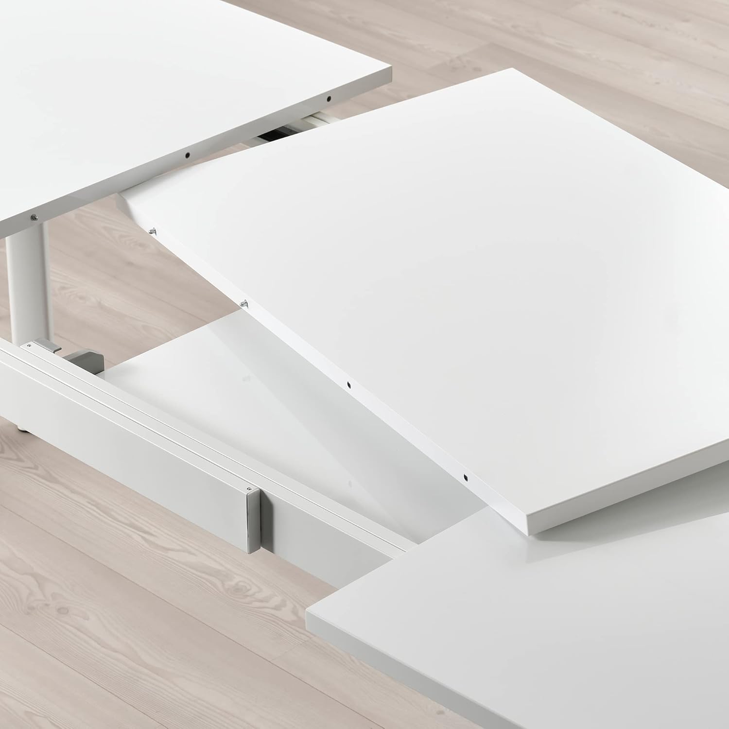 Close-up view of the extension mechanism of the IKEA STRANDTORP table