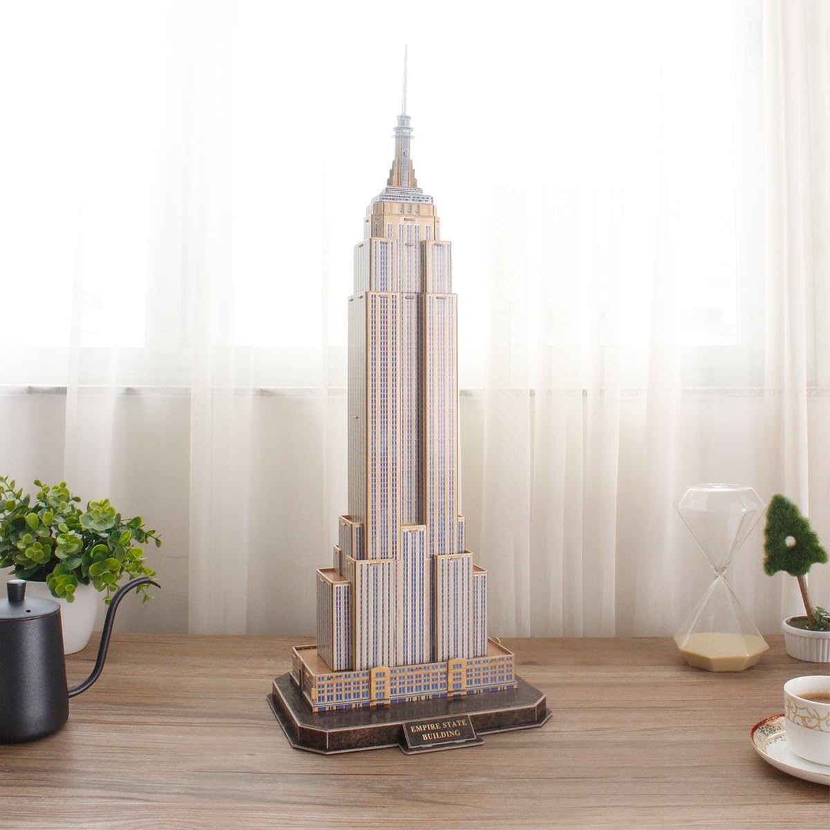 Completed CubicFun Empire State Building 3D puzzle on a wooden table