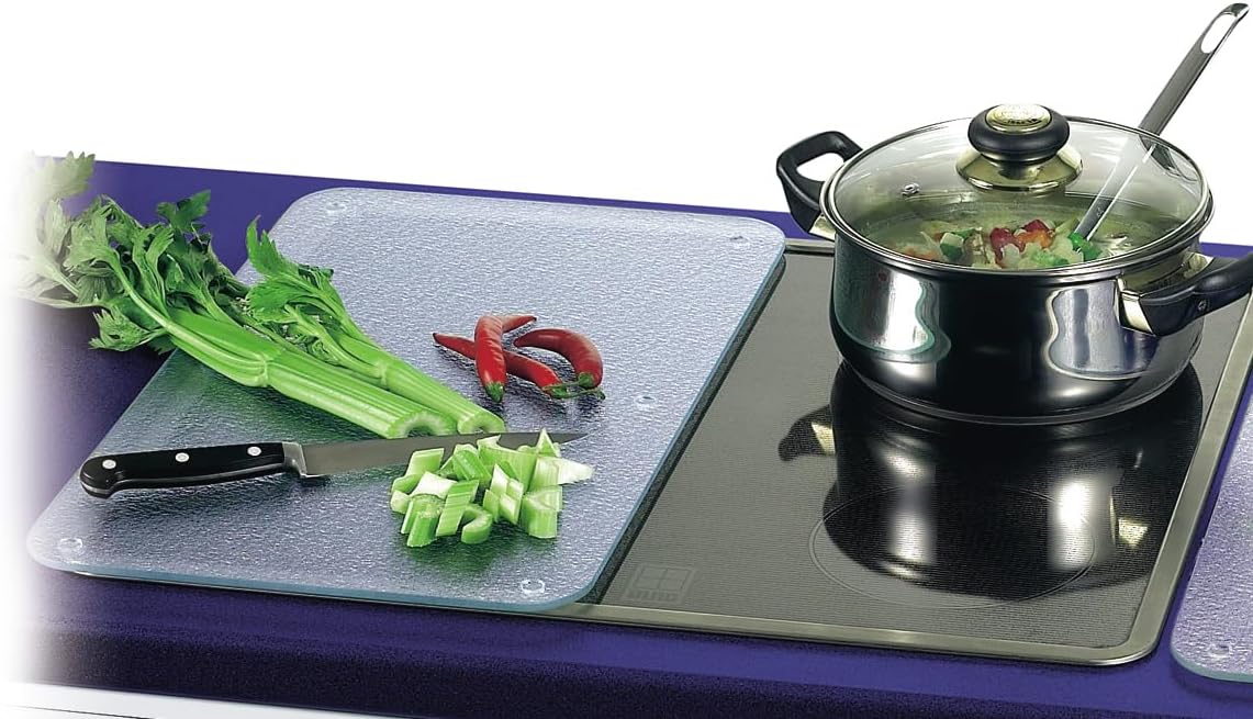 Jocca 6410 Vitroceramic Cover placed next to a cooking pot on a glass-ceramic cooktop, demonstrating its dual use.