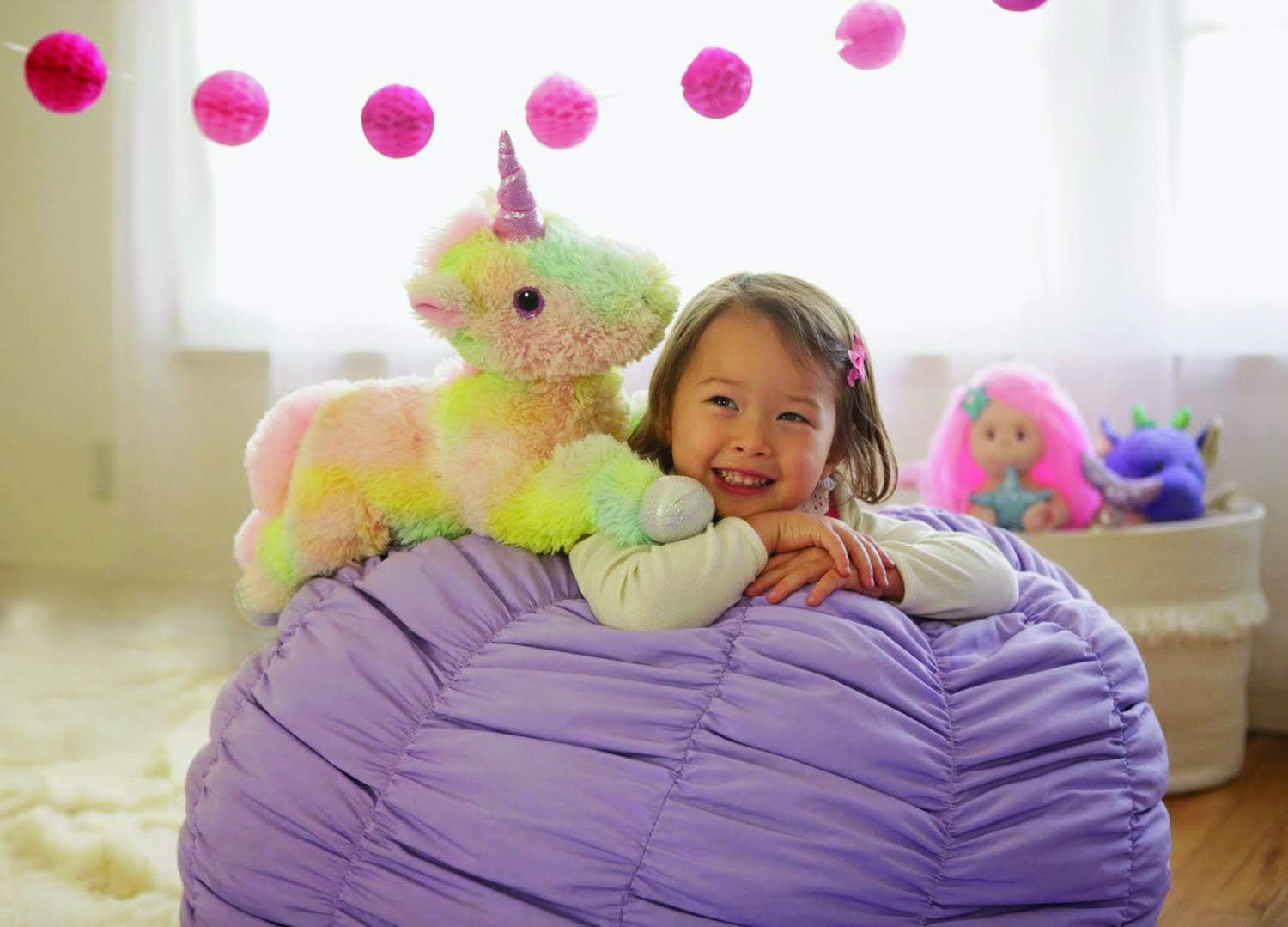 Child playing with Cuddle Barn Magical Sparkle Unicorn