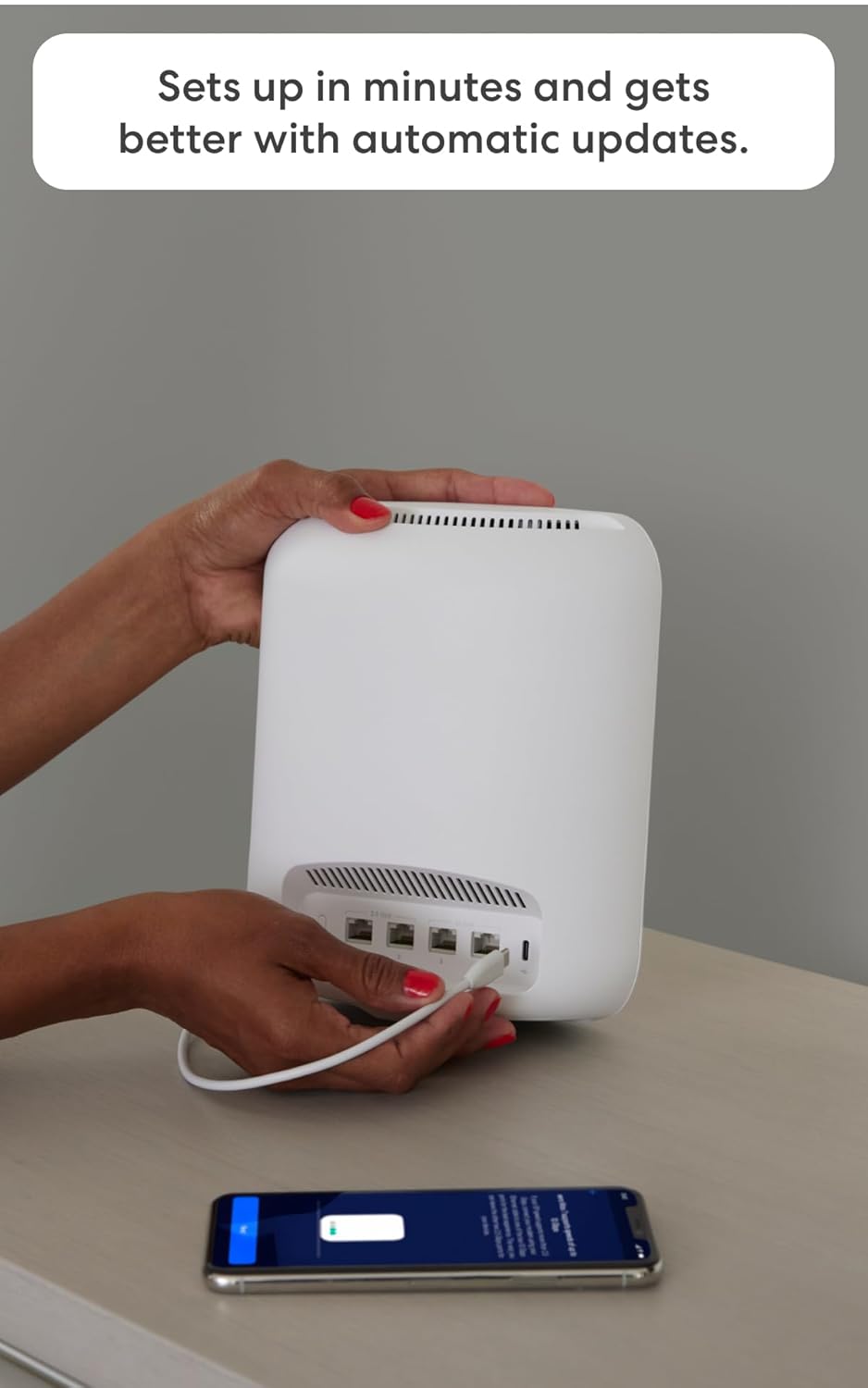 Hands connecting a cable to an eero Max 7 device with a smartphone showing the eero app in the foreground.