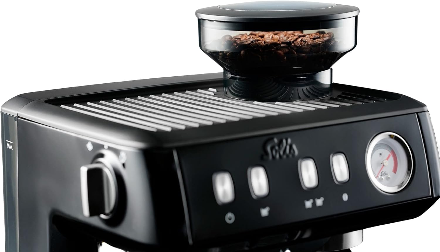 Hand frothing milk with the steam wand of the Solis espresso machine