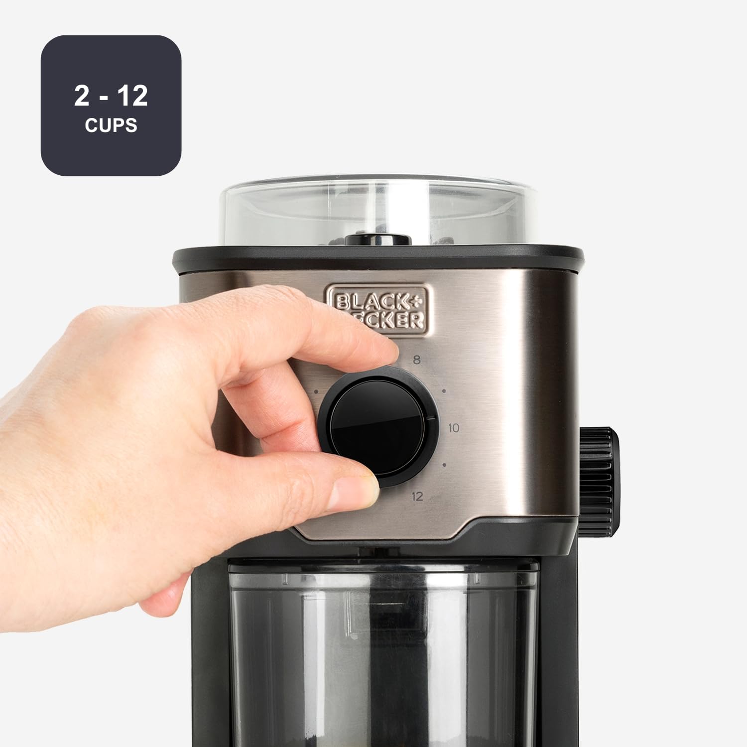 Hand adjusting the cup quantity dial on the Black+Decker coffee grinder