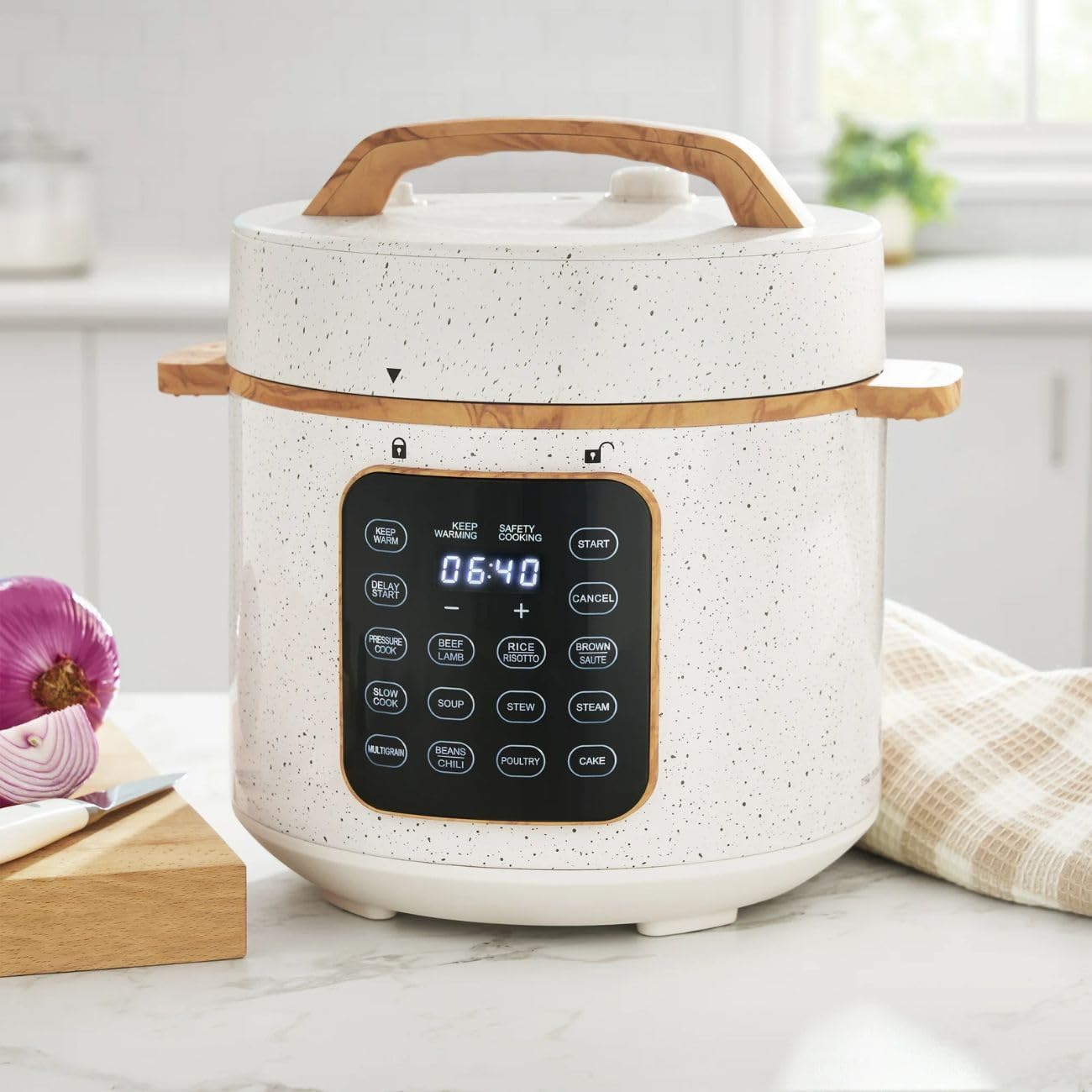 Close-up of the multi-cooker's touch control panel showing various preset buttons and digital timer