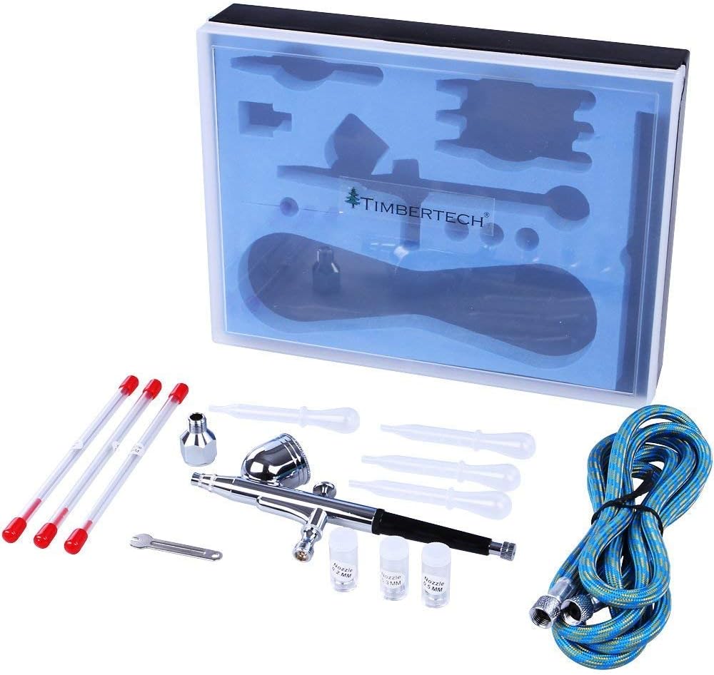 Components of the AG-134K airbrush kit, including the airbrush, hose, nozzles, needles, cups, spanner, and pipettes.