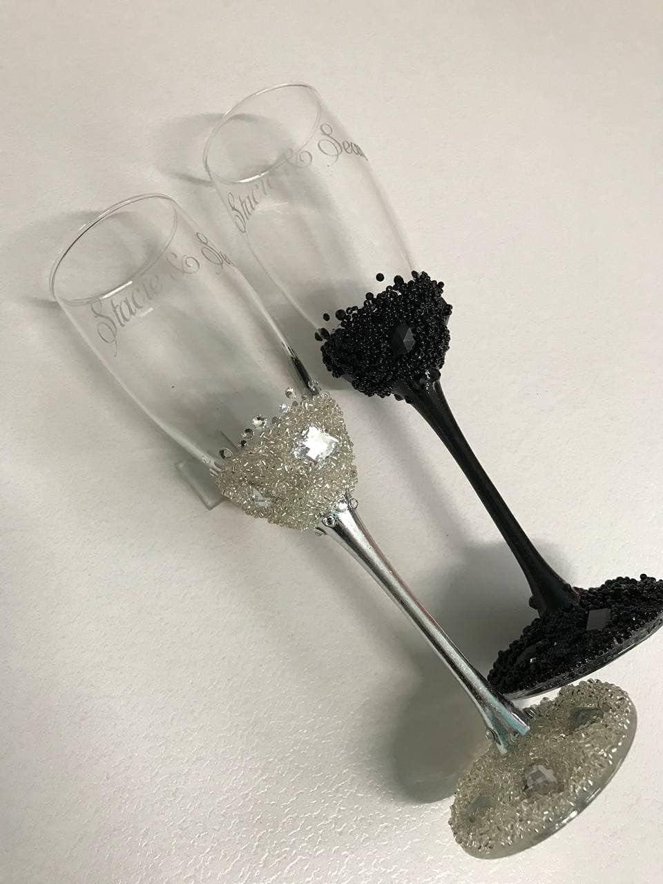 Personalized silver and black wedding flutes decorated with silver crystals