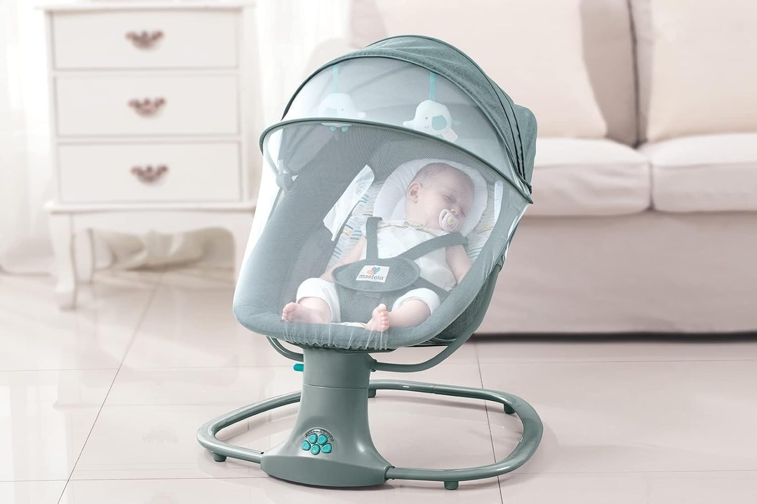 Infant in the Mastela Techno Green Infant Chair with the mosquito net and mobile attached.
