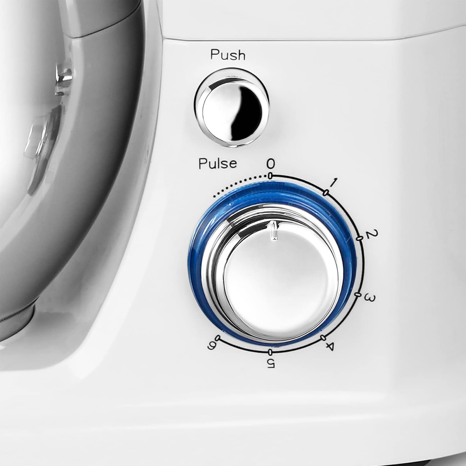 Close-up of the speed control dial and pulse button on the kitchen machine.