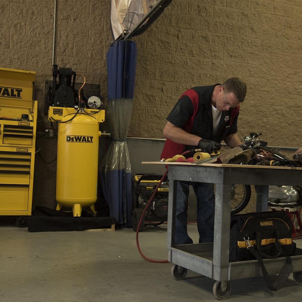 Person working with air compressor in background