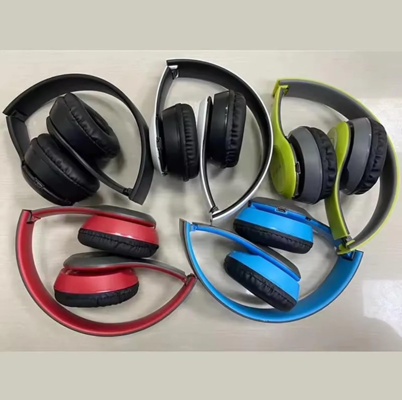 Multiple P47 Wireless Headphones in various colors, folded for storage.