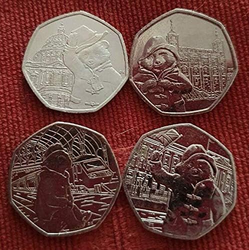 4 Paddington coins in sleeves. Uncirculated quality