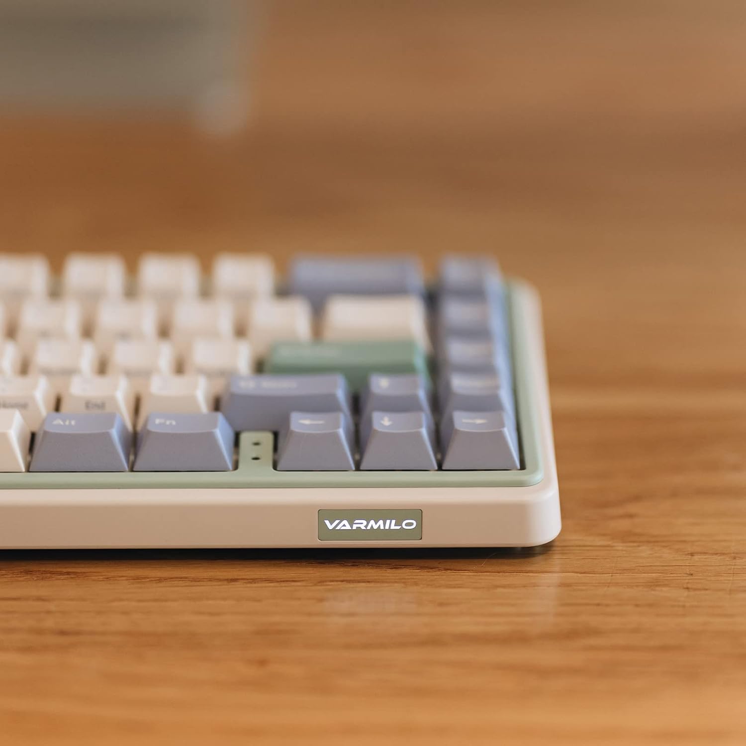 Close-up of the Varmilo Minilo VXH67 keyboard's side with the Varmilo logo illuminated.