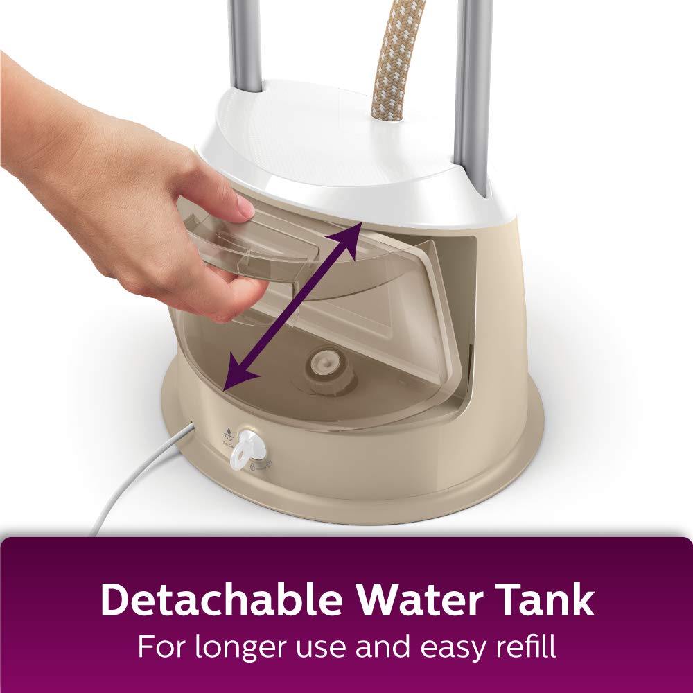Hand removing the detachable water tank from the steamer base.