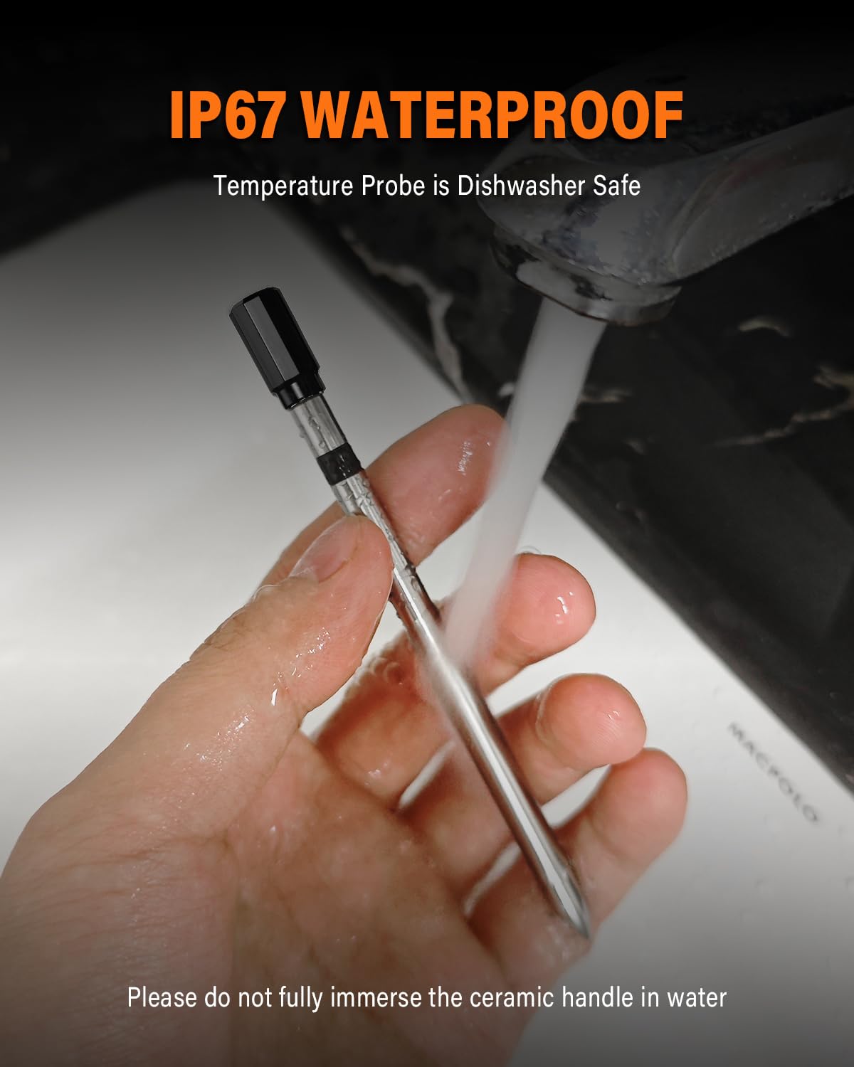 Hand holding the thermometer probe under running water, demonstrating its IP67 waterproof rating.