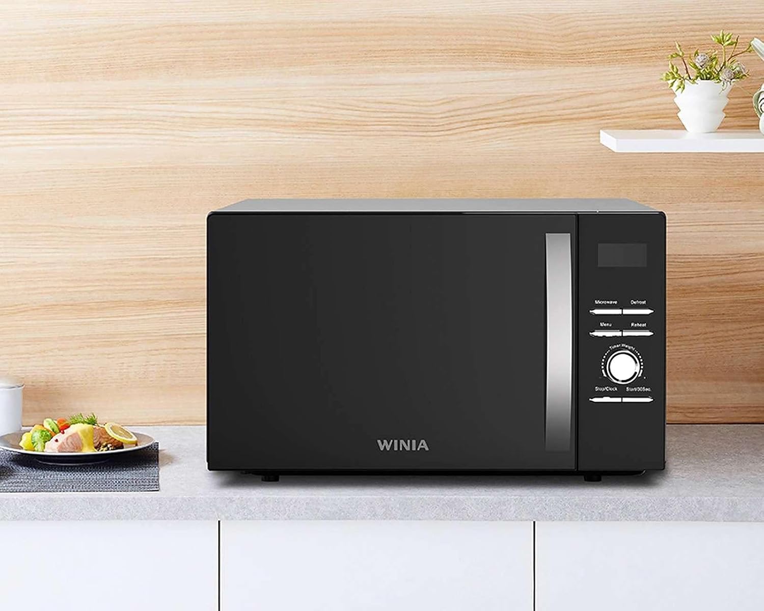 Winia KOS-1N1HBB Microwave Oven placed on a kitchen counter