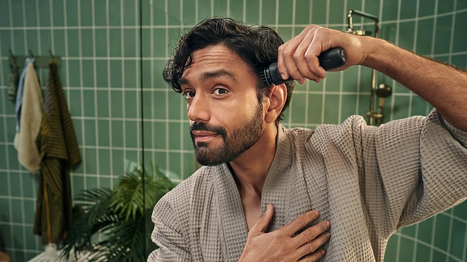 Man using Philips trimmer to trim his hair