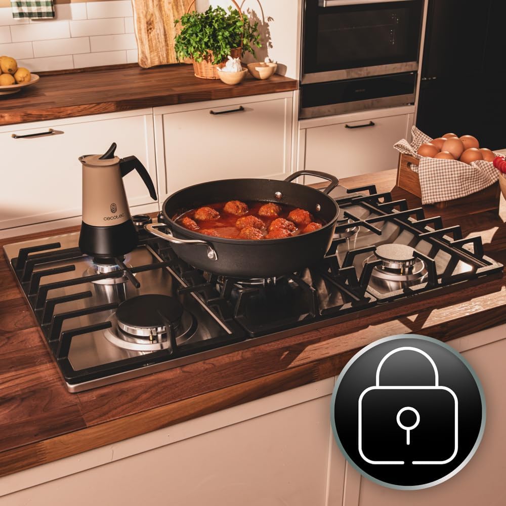 Hand adjusting a control knob on the gas hob