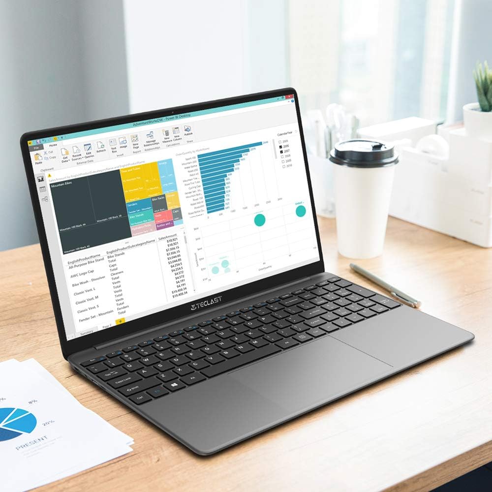 TECLAST F15S laptop open on a desk, displaying a spreadsheet, demonstrating its use for productivity tasks.