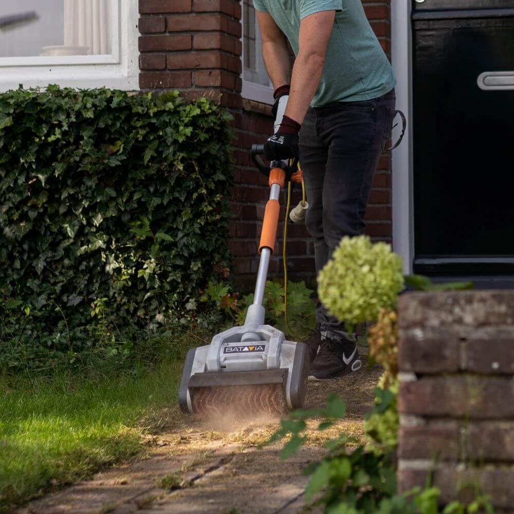 User operating Batavia Maxxbrush on a paved path