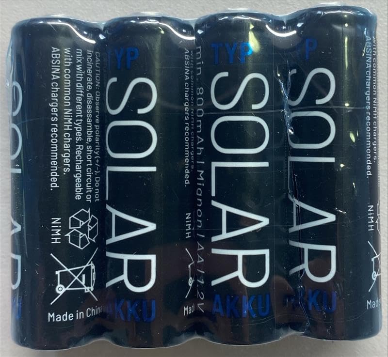 Close-up of ABSINA solar batteries in packaging, showing warnings about polarity, not incinerating, disassembling, short-circuiting, or mixing with different types of batteries.