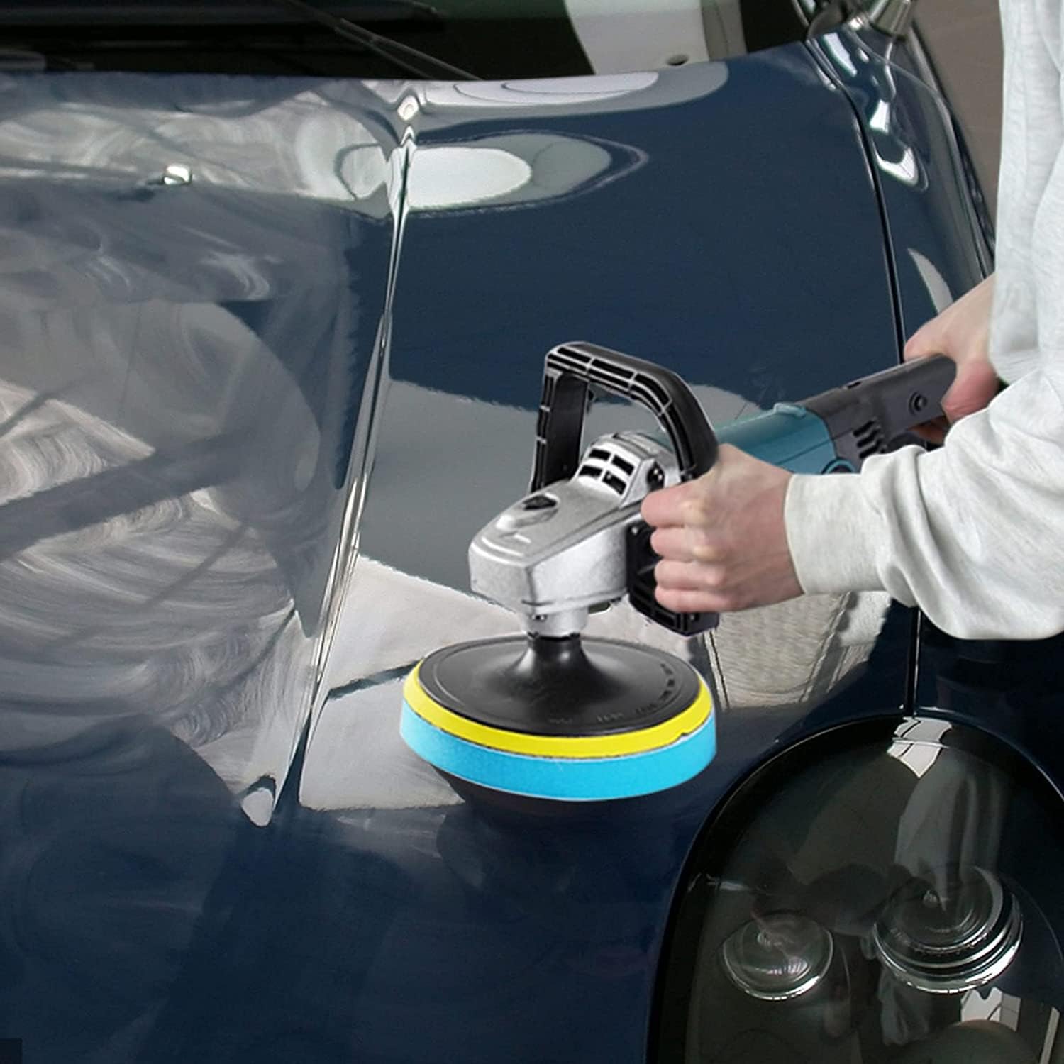 Person polishing a car with the buffer polisher