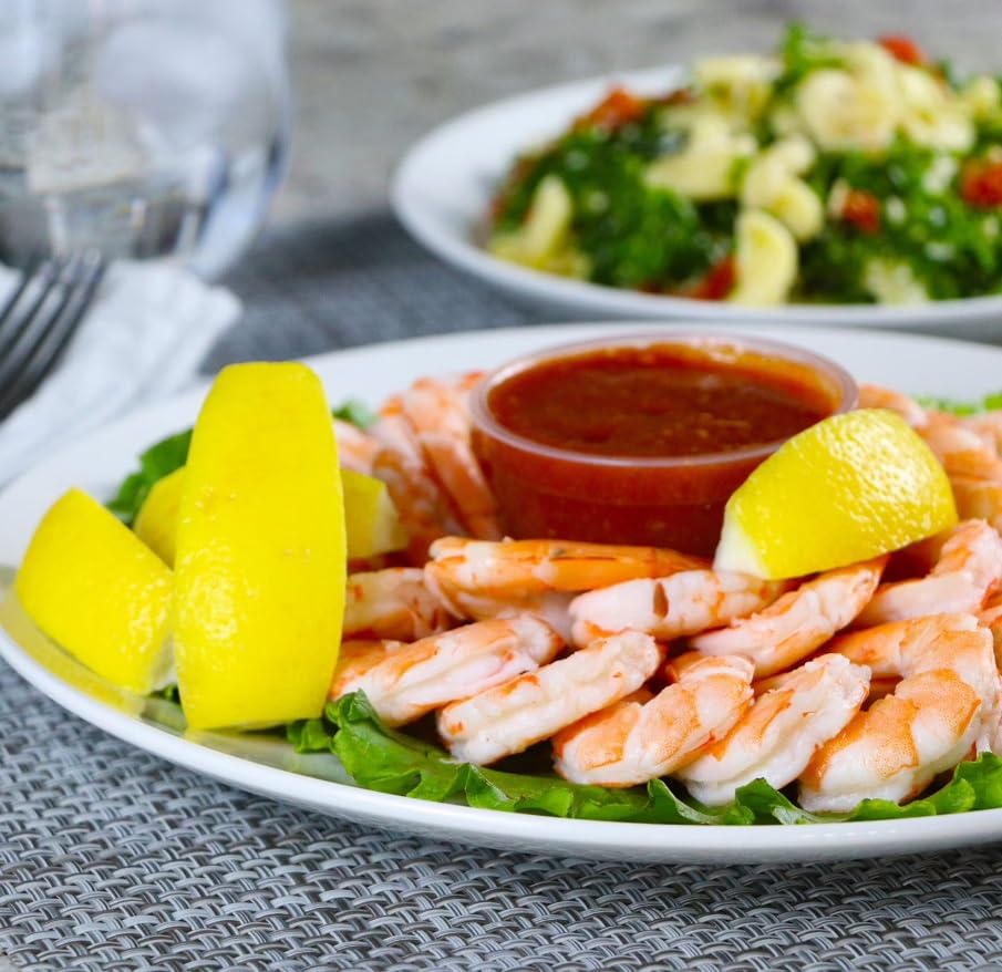 Shrimp Tray with Cocktail Sauce, Shrimp and zesty cocktail sauce in a party ready tray,It’s accompanied by fresh lemon wedges, adding a tangy twist to the dish. 1.5 POUND