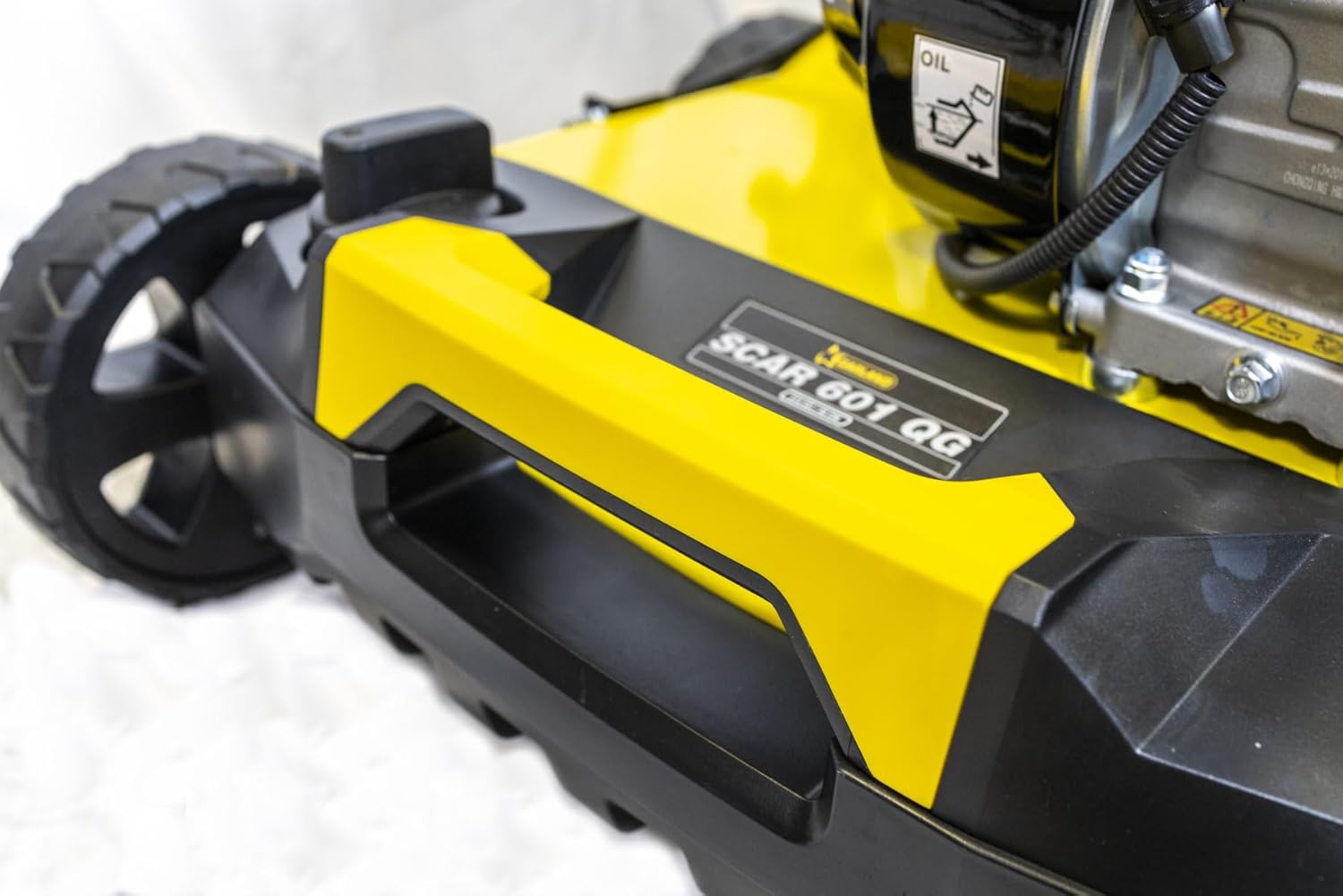 Close-up of the Garland scarifier deck showing the model name 'SCAR 601 QG' and handle.