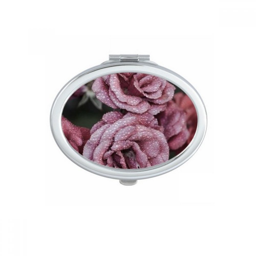 Miroir compact ovale pour maquillage en voyage avec motif de roses rouge foncé