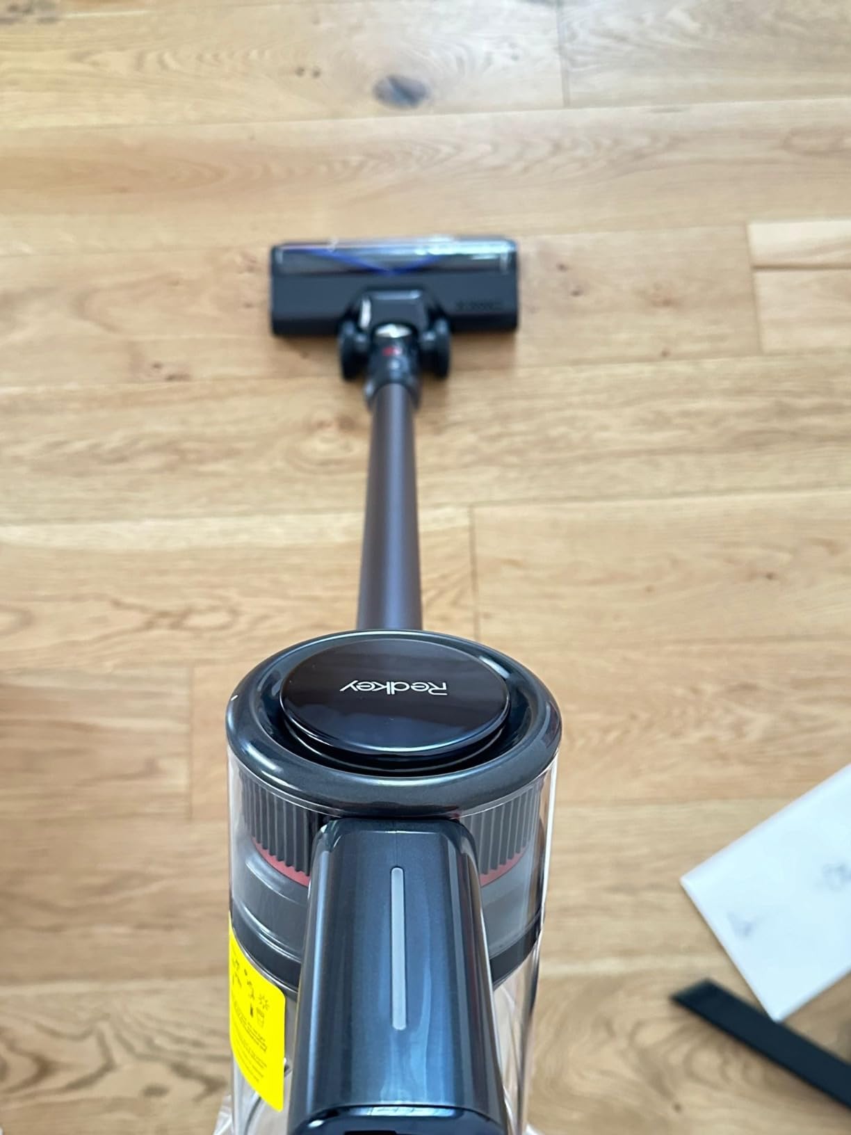 Redkey P9 Cordless Vacuum Cleaner in use, showing the LED brush