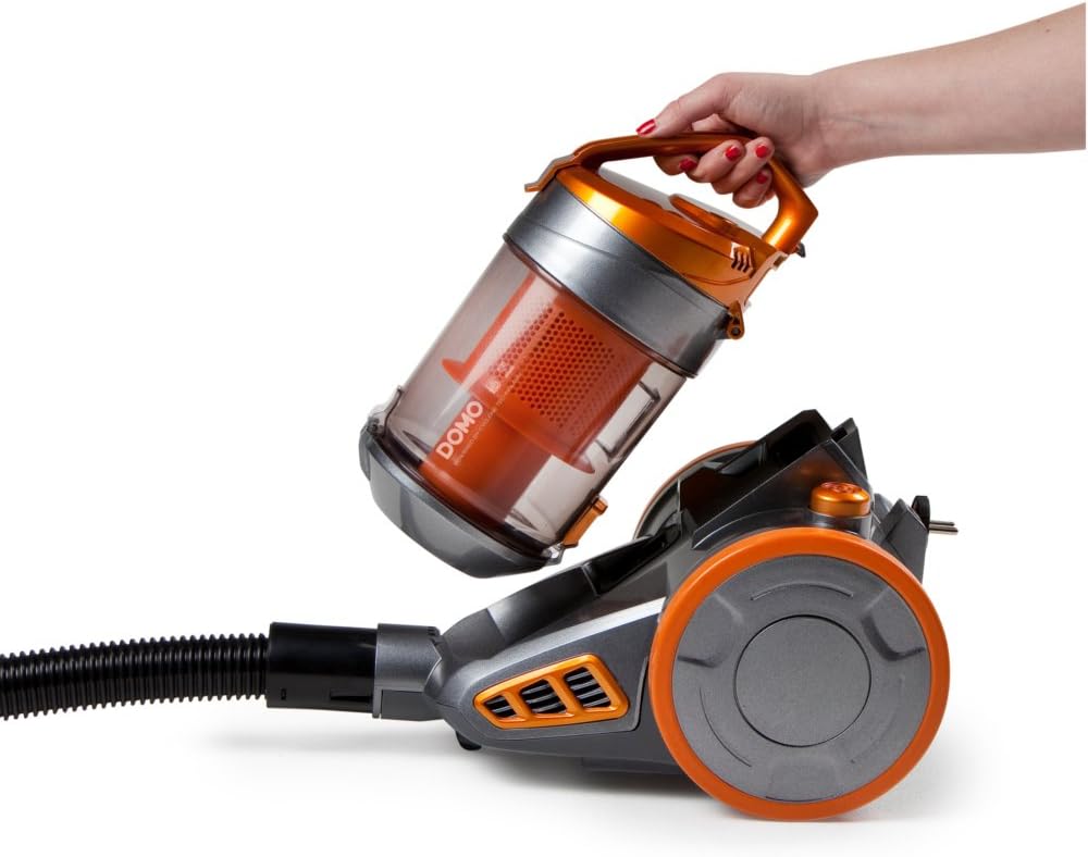 Hand removing dust container from Domo DO7280S Vacuum Cleaner