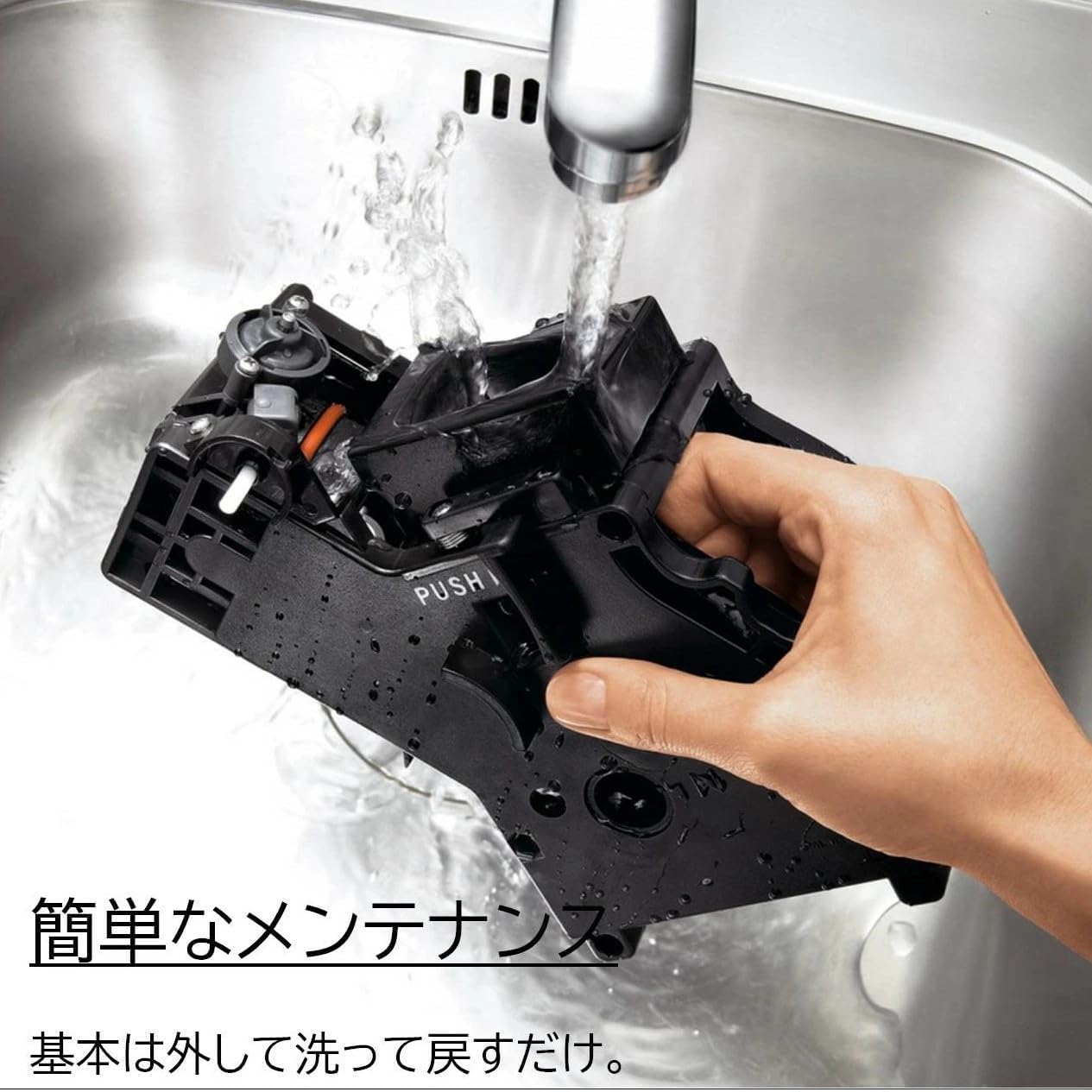 A hand holding a milk pitcher under the GAGGIA Besana's steam nozzle, frothing milk