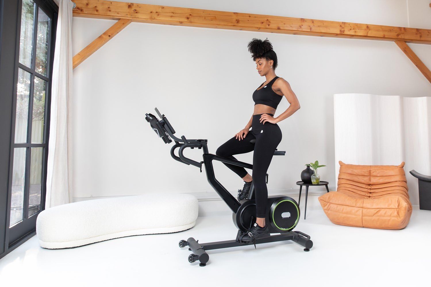 Woman adjusting the seat height on the VirtuFit Etappe 2.0i Indoor Cycle
