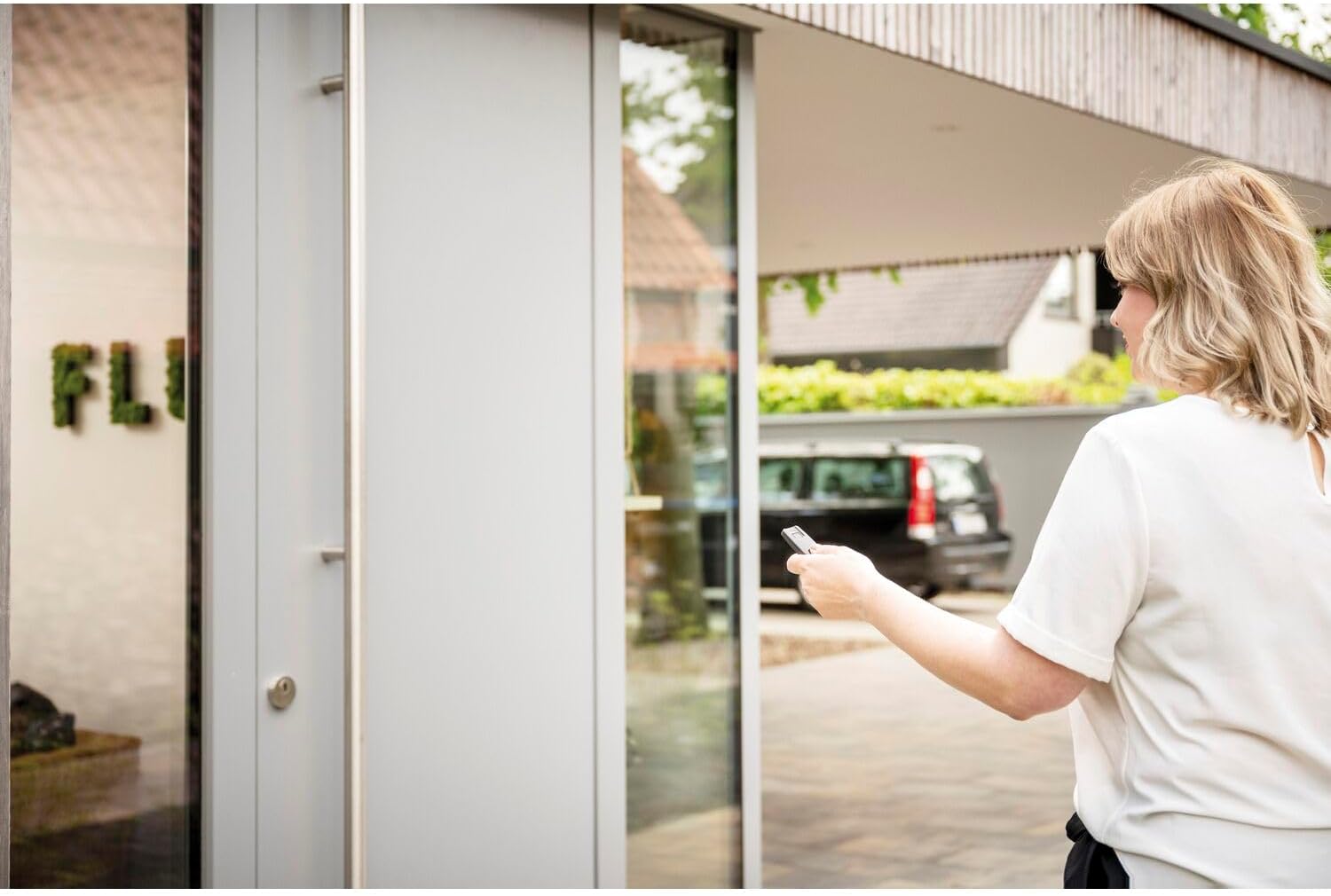 Person using ABUS remote control to open a door from outside