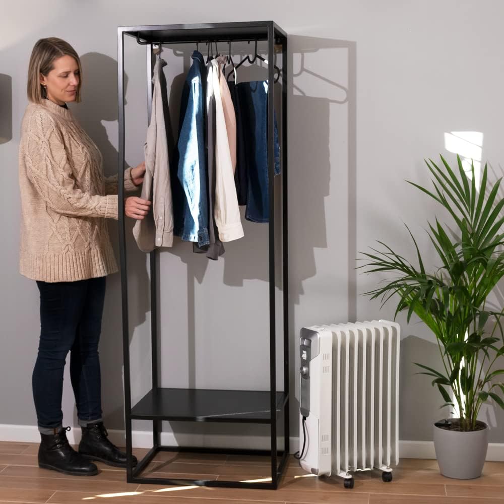 Radiator in use next to a clothes rack