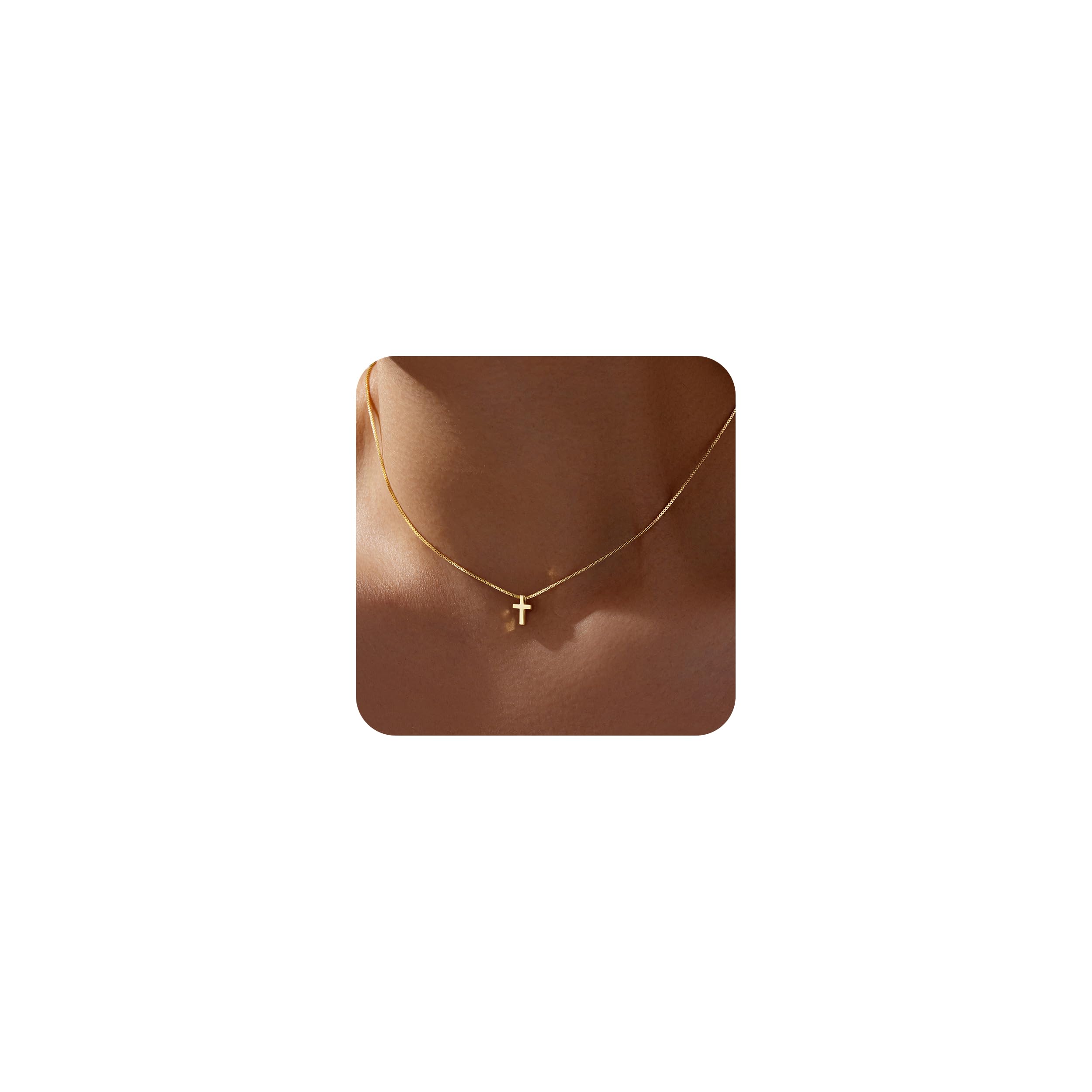Close-up of the Poxtex cross pendant and its delicate chain.