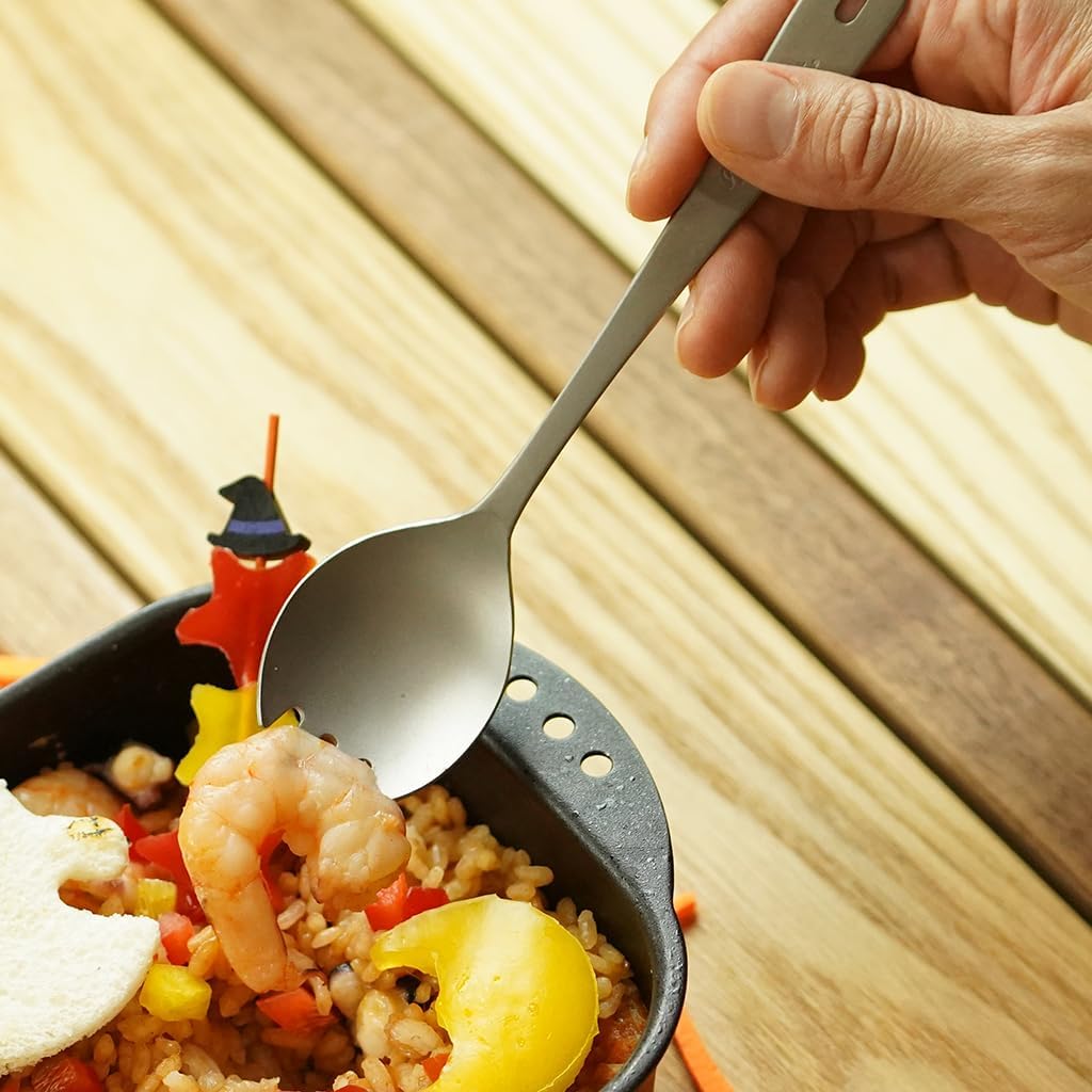 Hand holding Belmont BM-024 Titanium Fork Spoon with food