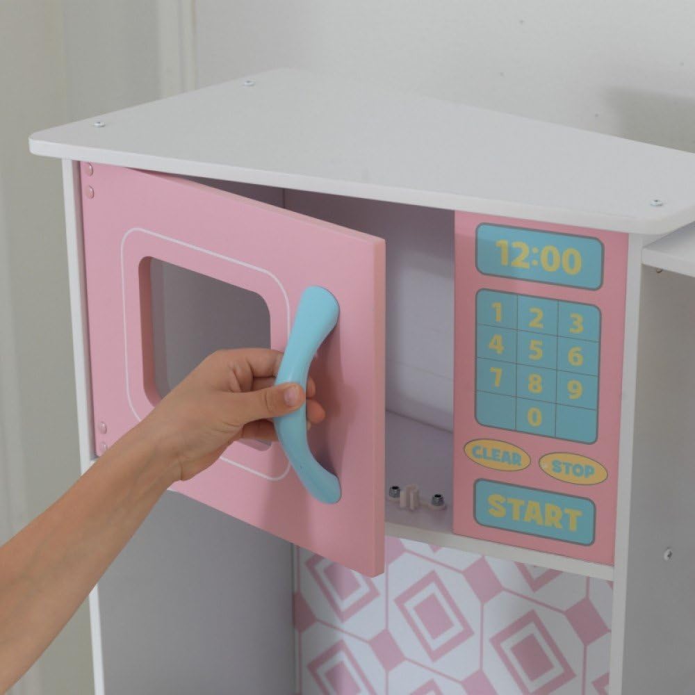 Child opening microwave door of play kitchen