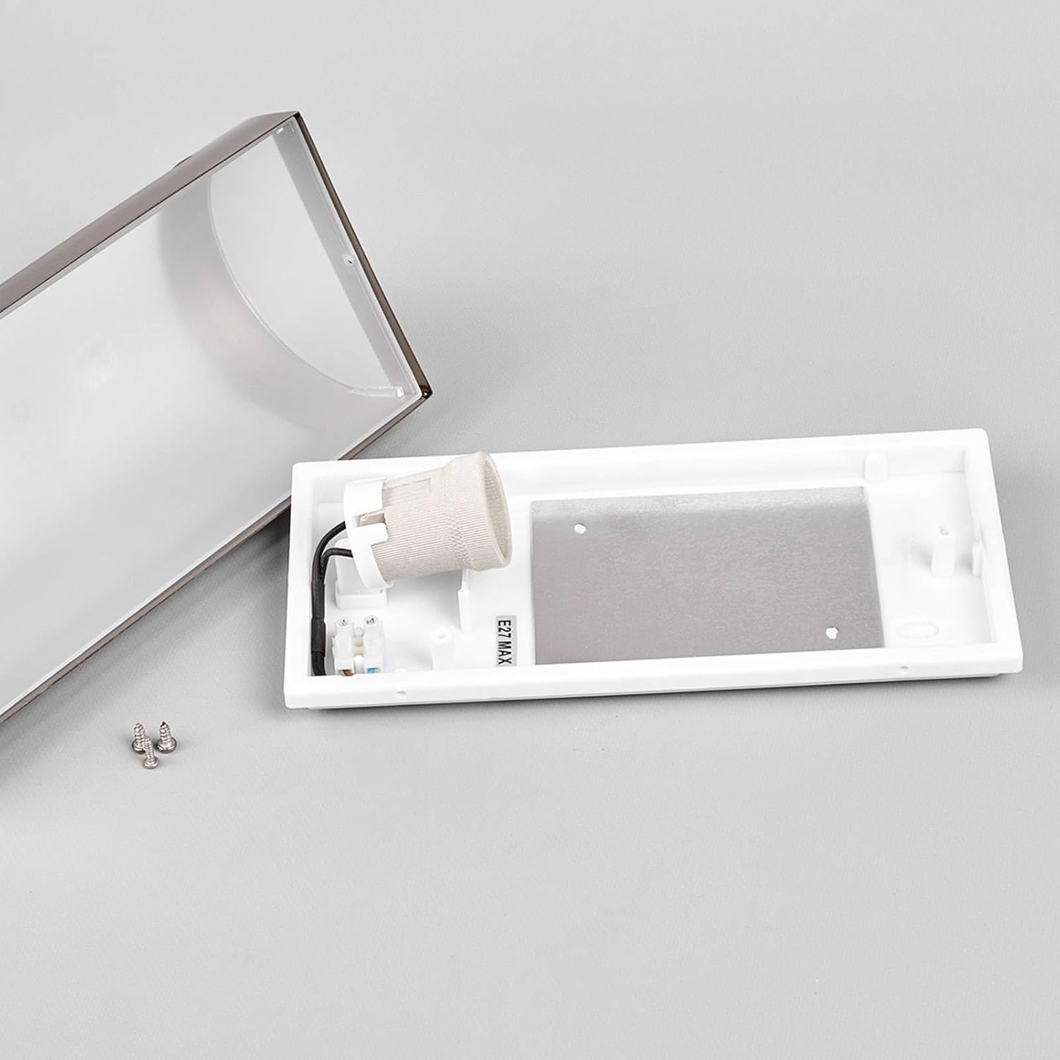 Internal view of the Lindby Outdoor Wall Light showing the E27 bulb socket and wiring area.