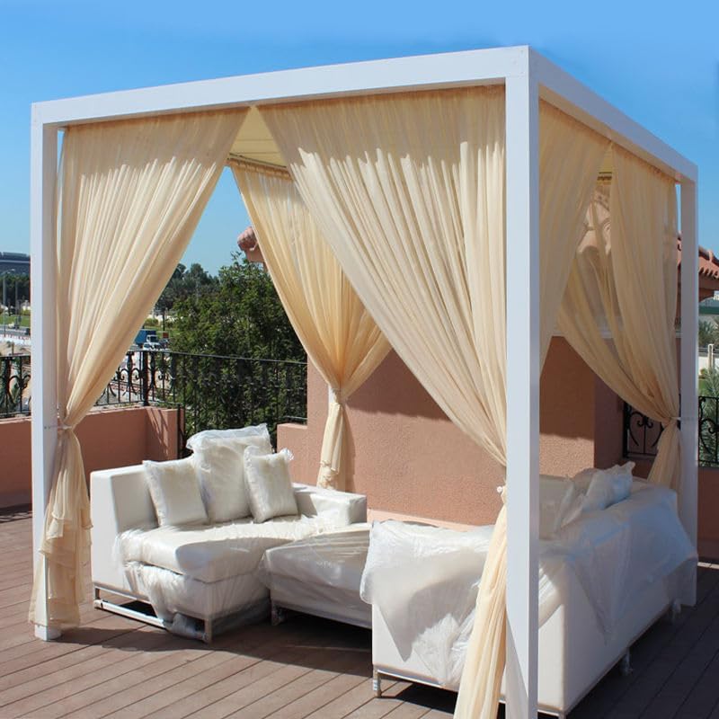 White pergola with flowing beige curtains on a rooftop patio