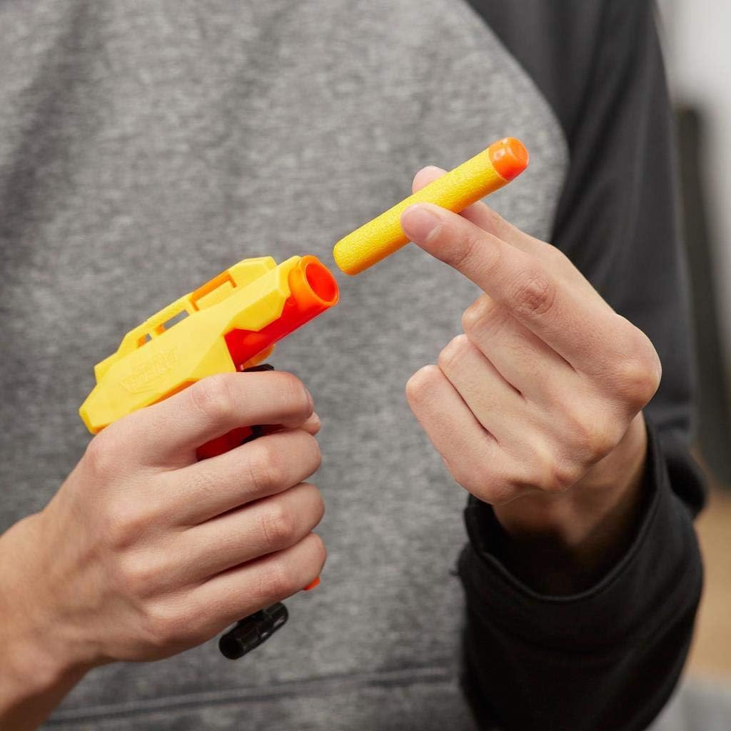 A hand inserting a yellow Nerf Elite dart into the orange barrel of the Nerf Alpha Strike Stinger SD-1 blaster.