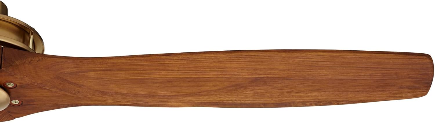 Close-up of a single walnut wood fan blade, highlighting its carved design.