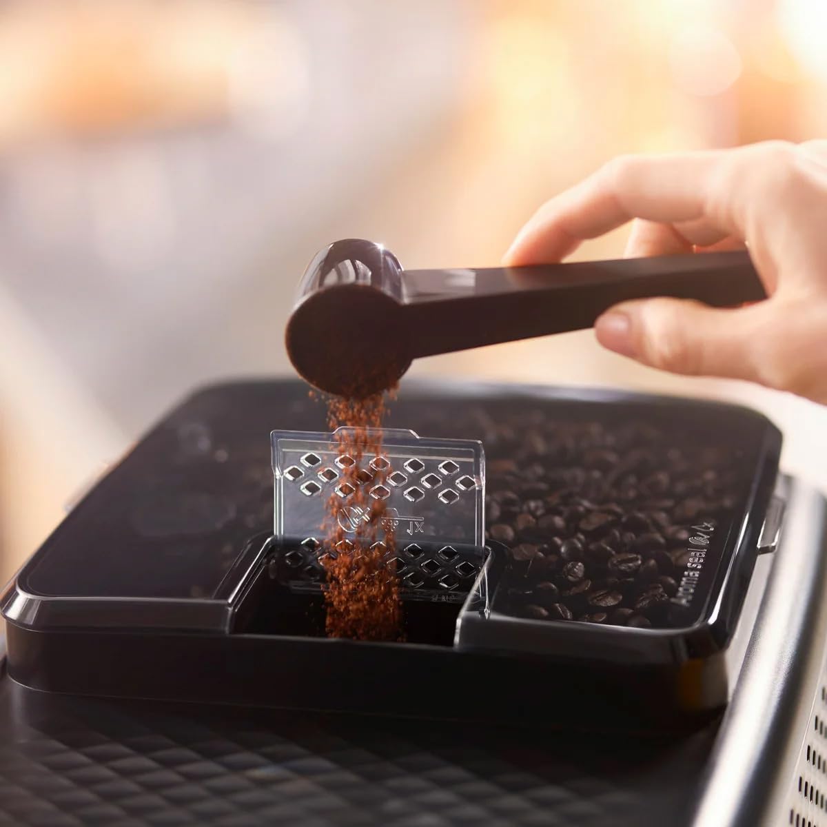 Pre-ground coffee being added to the pre-ground coffee compartment