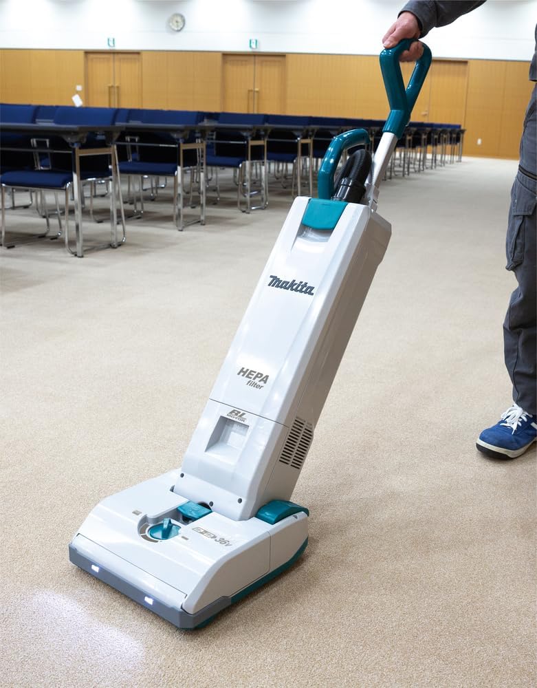 Man Operates Makita Cordless Upright Vacuum Cleaner
