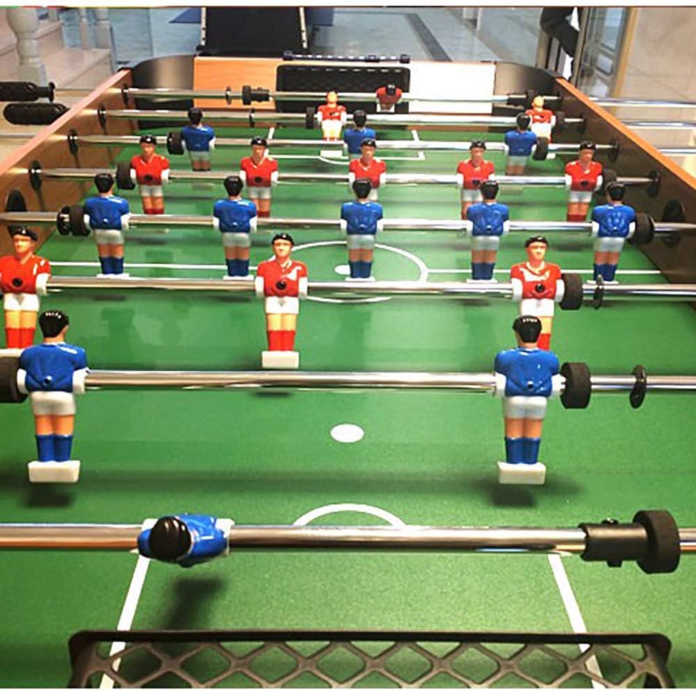 Close-up of foosball players on the green field
