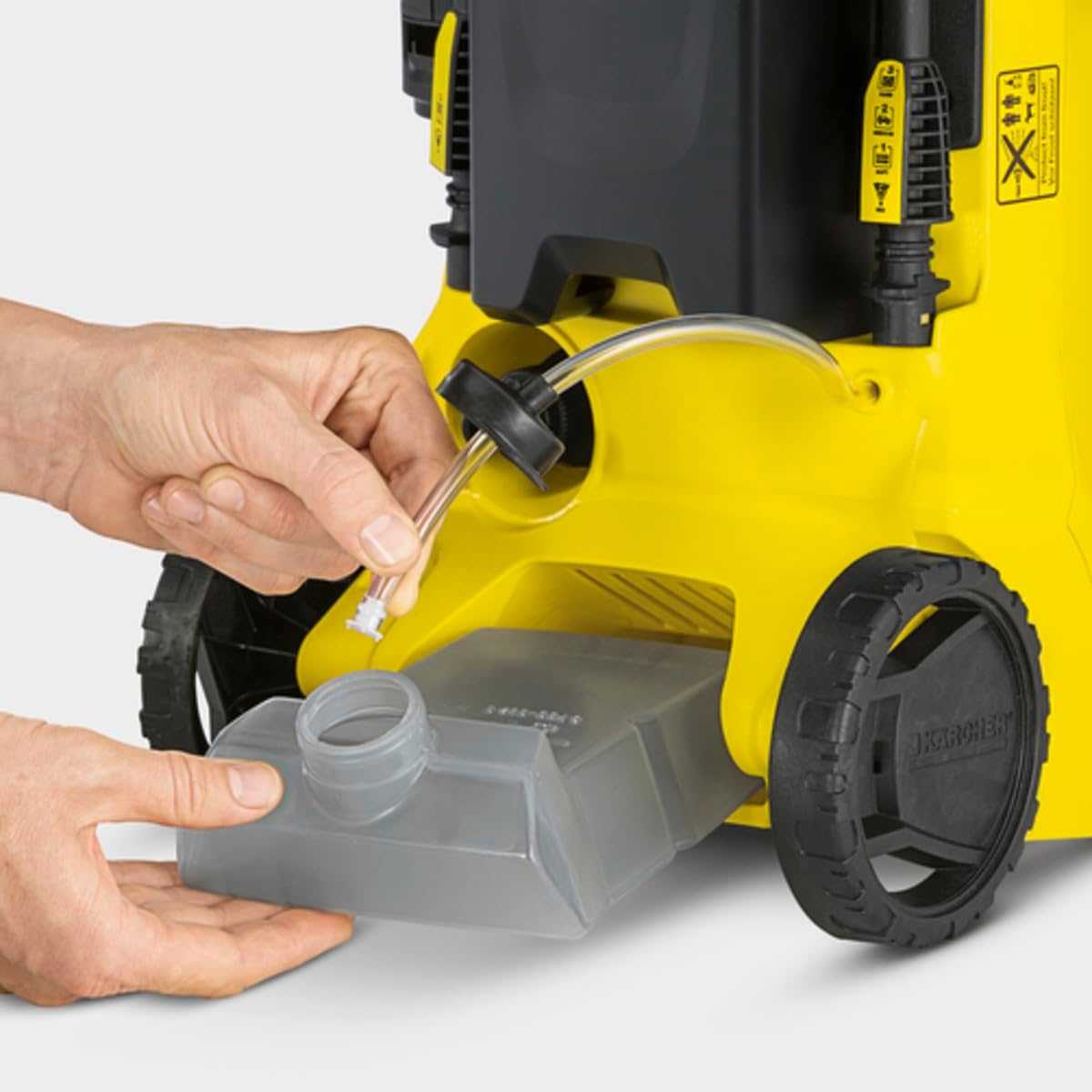 Hands inserting the detergent reservoir into the Karcher K 3 Car Pressure Washer.
